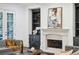 Living room with stone fireplace, built-in shelving, and access to the porch at 369 Pinecrest Ne Rd, Atlanta, GA 30342