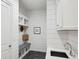 Stylish mudroom featuring shiplap walls, a bench, and a sink with storage at 369 Pinecrest Ne Rd, Atlanta, GA 30342