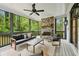 Inviting screened porch with a stone fireplace, comfortable seating, and scenic views at 369 Pinecrest Ne Rd, Atlanta, GA 30342