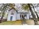 Backyard of white two-story home with wooden stairs leading to a deck at 3979 Sharon Spgs, Powder Springs, GA 30127
