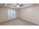 Spacious bedroom featuring a large window, ceiling fan, and tray ceiling at 3979 Sharon Spgs, Powder Springs, GA 30127