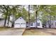 Charming single-story home featuring a two-car garage and a well-maintained front yard with mature trees at 3979 Sharon Spgs, Powder Springs, GA 30127