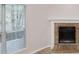 Close-up shot of a fireplace with a brick surround and white mantel, next to a large, bright window at 3979 Sharon Spgs, Powder Springs, GA 30127