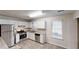 Modern kitchen with white cabinets, stainless steel appliances, granite countertops, and natural light at 3979 Sharon Spgs, Powder Springs, GA 30127
