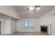Bright living room featuring hardwood floors, a fireplace, a ceiling fan, and a door to the outside at 3979 Sharon Spgs, Powder Springs, GA 30127
