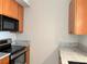 Close-up of kitchen with wood cabinets and granite countertops at 502 Pryor St # 207, Atlanta, GA 30312