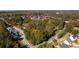 An aerial view captures the neighborhood highlighting lush greenery and surrounding roadways at 5098 Meadows Rd, Powder Springs, GA 30127
