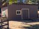 Exterior view of a shed or barn with a window and a large door, perfect for storage at 5098 Meadows Rd, Powder Springs, GA 30127