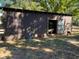 Outdoor view of a barn with an animal inside, with adequate space for sheltering livestock at 5098 Meadows Rd, Powder Springs, GA 30127