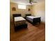 Cozy bedroom featuring two beds, laminate flooring, and a ceiling fan at 5098 Meadows Rd, Powder Springs, GA 30127