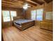 Cozy bedroom with wood paneled walls and ceiling, features a ceiling fan and hardwood floors at 5098 Meadows Rd, Powder Springs, GA 30127