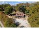A charming home sits on a spacious lot, surrounded by mature trees and lush landscaping at 5098 Meadows Rd, Powder Springs, GA 30127