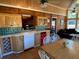 Open floor plan kitchen with tile backsplash, light cabinetry, and a dining area with a wood table at 5098 Meadows Rd, Powder Springs, GA 30127