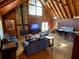 A spacious living area features vaulted wood ceilings, a stone fireplace, and wood floors at 5098 Meadows Rd, Powder Springs, GA 30127
