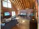 A spacious living area features vaulted wood ceilings, a stone fireplace, and wood floors at 5098 Meadows Rd, Powder Springs, GA 30127
