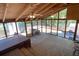 Large screened porch features high ceilings, ample windows, and views of the surrounding landscape at 5098 Meadows Rd, Powder Springs, GA 30127