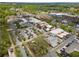Aerial view of neighborhood with mature trees, street parking, and commercial buildings at 815 Paden St, Woodstock, GA 30188