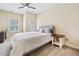 Cozy bedroom with neutral tones, soft carpet and lots of natural light from windows with plantation shutters at 815 Paden St, Woodstock, GA 30188