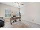 Neutral bedroom with modern ceiling fan, two windows, and light-colored walls at 815 Paden St, Woodstock, GA 30188
