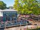 Outdoor view of local brewery with a spacious patio seating area, shaded by mature trees for an inviting experience at 815 Paden St, Woodstock, GA 30188