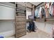 Walk in closet with built in wooden shelves, drawers and baskets for ultimate organization at 815 Paden St, Woodstock, GA 30188