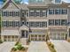 Beautiful townhome with a two-car garage, complemented by a meticulously landscaped front yard at 815 Paden St, Woodstock, GA 30188