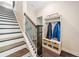 Hallway with black and white staircase and hall tree with coat hooks and storage benches at 815 Paden St, Woodstock, GA 30188