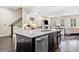 Well-lit kitchen with an island, stainless steel appliances, and an open layout to the living room at 815 Paden St, Woodstock, GA 30188