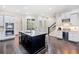 Stylish kitchen with stainless steel appliances, white cabinets, and a granite island at 815 Paden St, Woodstock, GA 30188