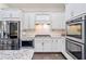 Beautiful kitchen with white cabinets, stainless steel appliances, granite counters, and tile backsplash at 815 Paden St, Woodstock, GA 30188