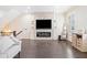 Cozy living room featuring a modern fireplace, hardwood floors, and built-in shelving at 815 Paden St, Woodstock, GA 30188
