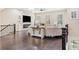 Bright living room featuring a stone fireplace, hardwood floors, and modern ceiling fan at 815 Paden St, Woodstock, GA 30188