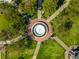 Aerial view of a neighborhood park featuring a water feature, benches, pathways, and mature trees for relaxation at 815 Paden St, Woodstock, GA 30188