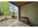 Covered patio with outdoor grill, brick pavers, bench and view of the backyard at 815 Paden St, Woodstock, GA 30188
