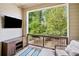 Covered patio features outdoor seating and nature views, plus mounted flatscreen TV at 815 Paden St, Woodstock, GA 30188