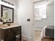 Bathroom with vanity and mirror, adjacent to a bedroom, blending comfort and convenience at 136 Flora Ne Ave, Atlanta, GA 30307