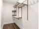 Walk-in closet with custom shelving, hanging rods, and hardwood floors at 136 Flora Ne Ave, Atlanta, GA 30307