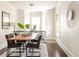 Stylish dining area with modern table and chairs, with decorative rug and plant accents at 136 Flora Ne Ave, Atlanta, GA 30307