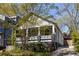 Charming home with a welcoming front porch framed by lush landscaping and driveway at 136 Flora Ne Ave, Atlanta, GA 30307