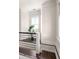 Stairway landing with modern railing, hardwood floors, and ample natural light at 136 Flora Ne Ave, Atlanta, GA 30307