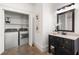 Convenient laundry area next to a bathroom with washer, dryer, and ample storage space at 136 Flora Ne Ave, Atlanta, GA 30307