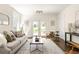 Bright living room featuring a neutral color palette, stylish furniture, and French doors to the backyard at 136 Flora Ne Ave, Atlanta, GA 30307