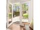 Patio view through open French doors showing backyard with fence, grass, and stepping stone area at 136 Flora Ne Ave, Atlanta, GA 30307