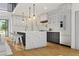 Gourmet kitchen with an island, quartz countertops, modern lighting, and stainless steel appliances at 1484 N Druid Hills Ne Rd, Brookhaven, GA 30319