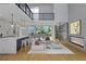 Bright open concept living space featuring a fireplace, wine cellar, white sofas, and open staircase at 1484 N Druid Hills Ne Rd, Brookhaven, GA 30319