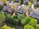 Aerial view of the home nestled among mature trees and well-maintained lawns in a residential neighborhood at 1754 Water Springs Way, Dacula, GA 30019