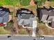 An aerial view of the home showing the roof, driveway, landscaping, and surrounding neighborhood at 1754 Water Springs Way, Dacula, GA 30019