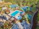 Community aerial view featuring playground, swimming pool, clubhouse, basketball and tennis courts all surrounded by mature trees at 1754 Water Springs Way, Dacula, GA 30019