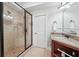 Bathroom featuring tile shower with glass doors and vanity with granite countertop at 1754 Water Springs Way, Dacula, GA 30019