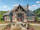 Exterior of the community clubhouse featuring a grand stone and brick facade and lush landscaping at 1754 Water Springs Way, Dacula, GA 30019